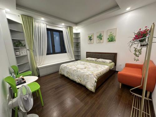 a bedroom with a bed and a desk and a chair at Rose house in Ðình Loan