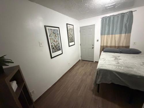a bedroom with a bed and two pictures on the wall at Downtown Taylor Private Entry Room 1 in Phoenix