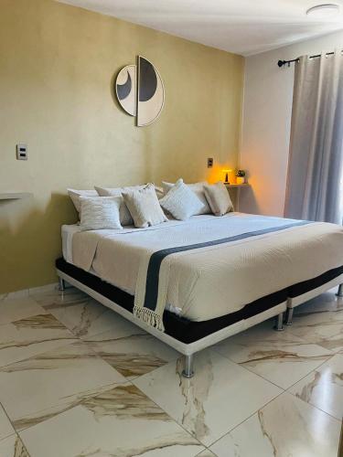a bedroom with a large bed in a room at Casa Mancera Oaxaca in Yelateni