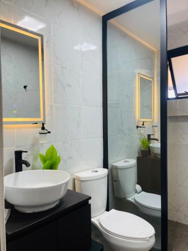 a bathroom with a white toilet and a sink at Casa Mancera Oaxaca in Yelateni
