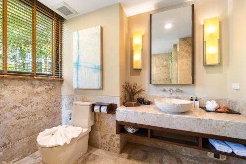a bathroom with a sink and a toilet at CasaVela 213 - 2BR apartment Seaview in Natien Beach