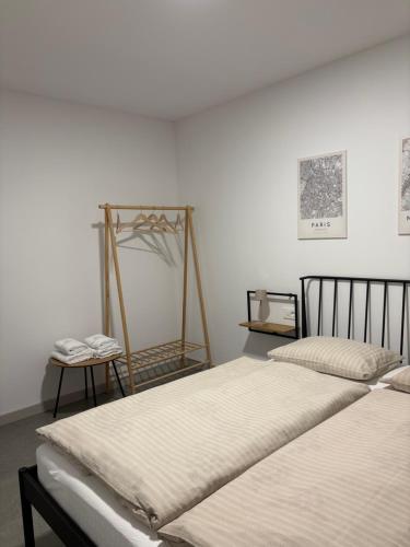 a bedroom with two beds and a table with a scale at Apartment Delux in Posušje