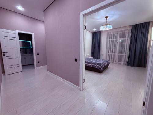 a room with a door open to a bedroom at Atamura 1 in Karagandy