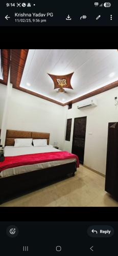 a bedroom with a bed with a red comforter at ROOMS vala in Varanasi