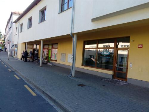 a building on the side of a street with people standing outside at Apartmá Kateřina Velké Losiny in Velké Losiny