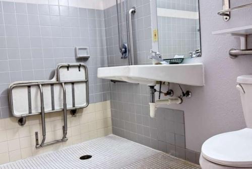 a bathroom with a sink and a toilet at Coratel Inn & Suites by Jasper Hastings in Hastings