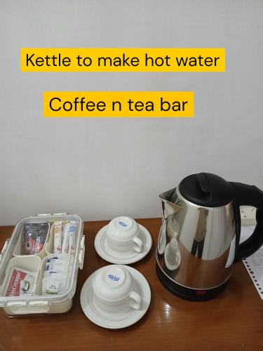 a table with a coffee pot and a tea bar at K77 Backpackers - Jungle Tours in Medan