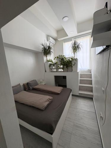 a small bedroom with a bed and a staircase at INDUSTRIAL STUDIO 1 in Ljubljana