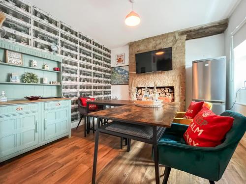a kitchen with a dining table and a fireplace at The Badger Sett in Hinderwell