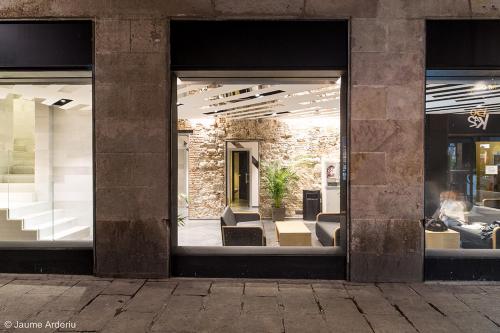 a window of a store with couches in it at Barcelona House in Barcelona