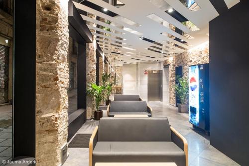 a row of couches in an office lobby at Barcelona House in Barcelona