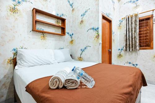 a bedroom with a bed with towels on it at Queen Residence Ancol RedPartner in Jakarta