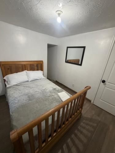a bedroom with a wooden bed and a door at Downtown Taylor Room 4 in Phoenix