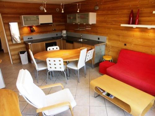 a kitchen with a table and chairs and a couch at Résidence Marmottes Ii - 3 pièces 6 personnes MAE-2780 in Orcières