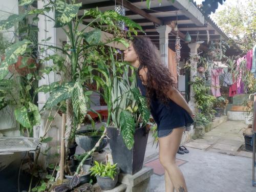a woman standing next to a potted plant at ADOBE AFFECTIOn in Tangalle