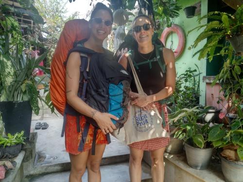 two women standing next to each other in front of plants at ADOBE AFFECTIOn in Tangalle