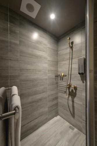 a bathroom with a shower with a glass door at City Suites - Kaohsiung Pier2 in Kaohsiung