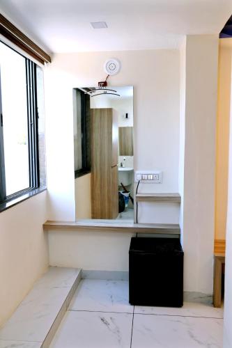 a bathroom with a mirror and a sink at hotel cloud 20 in Jambusar