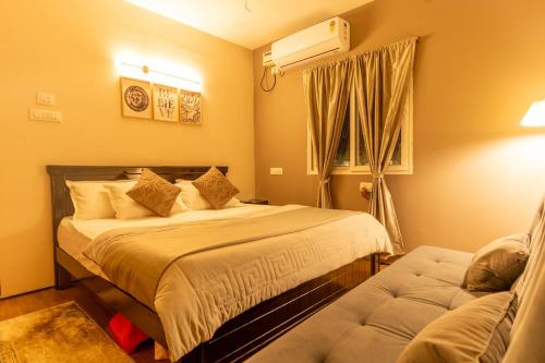 a bedroom with a bed and a couch in it at The Leafyard Container Home in Venkatāpur