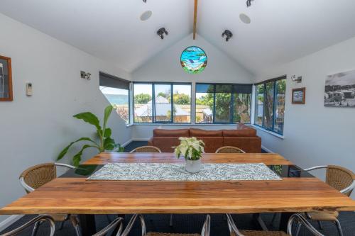 a dining room with a wooden table and a couch at BIG4 Middleton Beach Holiday Park in Albany