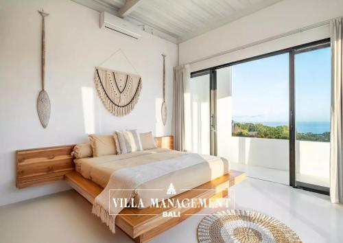 a bedroom with a bed and a large window at Villa Maracuya in Pecatu Bali - Spacious 3 Bedroom with Pool in Badung