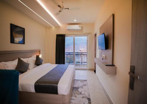 a hotel room with a bed and a balcony at Alpine Retreat in Narendranagar