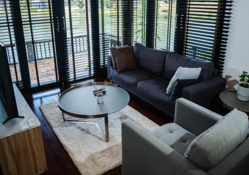 a living room with a couch and a table at Base 22 Hatyai in Ban Rai
