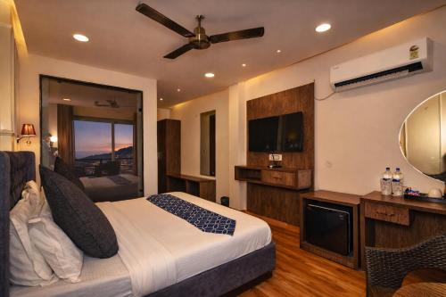 a hotel room with a bed and a television at AH Grand Villa - Hotel Near Dalai Lama Temple in McLeod Ganj