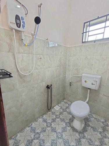 a bathroom with a toilet and a shower at Homestay Che Naa in Kuantan