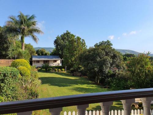 a view from a balcony of a house with a yard at Sunrise Guesthouse in Greytown