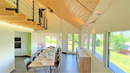 a large dining room with a long table and chairs at Chalet - Magnifique chalet d'architecte 10 pers MAE-2774 in Les Prés