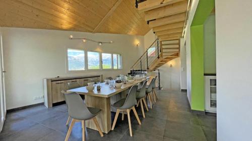a dining room with a long table and chairs at Chalet - Magnifique chalet d'architecte 10 pers MAE-2774 in Les Prés