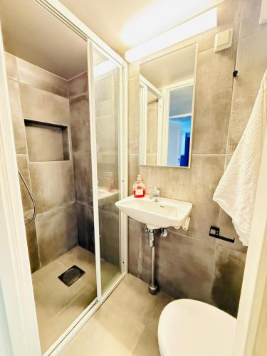 a bathroom with a shower and a sink at Haven Home in Stavanger