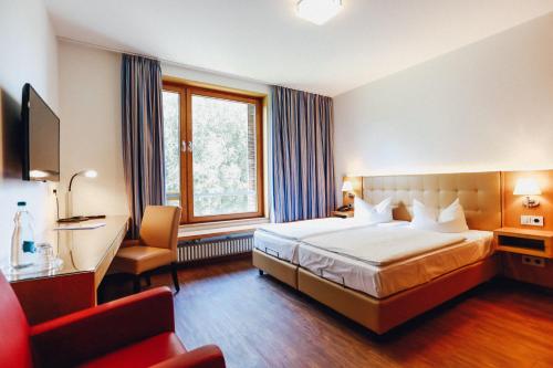מיטה או מיטות בחדר ב-Ostseehotel Dierhagen
