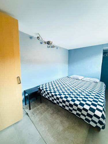 a bedroom with a bed with a blue wall at Haven Home in Stavanger