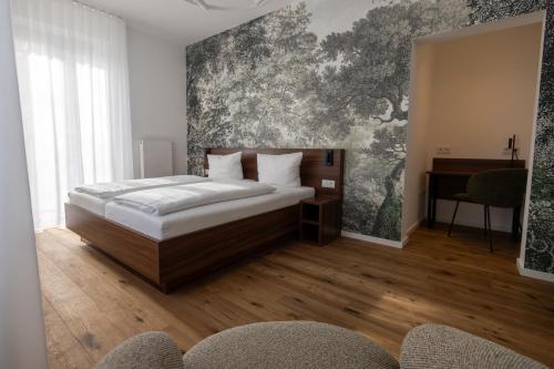 a bedroom with a bed and a painting on the wall at Palazzo Hotel in Mannheim