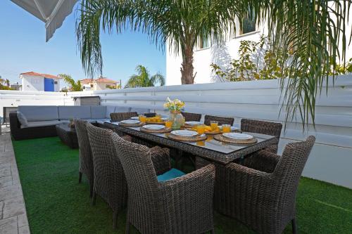 a table with fruit on it on a patio at Villa Calliopi in Protaras