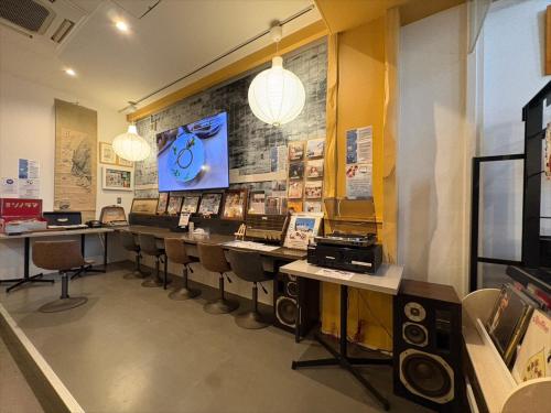 a room with a row of tables and chairs at Retrospect Stay Yokohama Chinatown in Yokohama