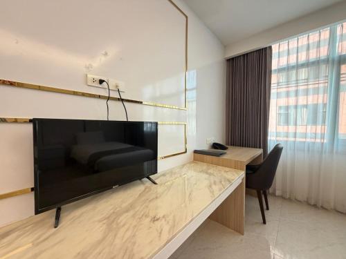 a living room with a large flat screen tv at Palette Luxe Jomtien Beach Pattaya in Jomtien Beach