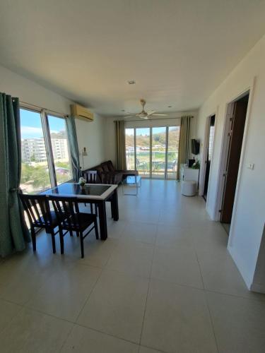 a living room with a table and chairs and a couch at 266 @The Seacraze in Hua Hin
