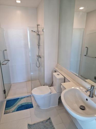 a bathroom with a toilet and a sink and a shower at 266 @The Seacraze in Hua Hin