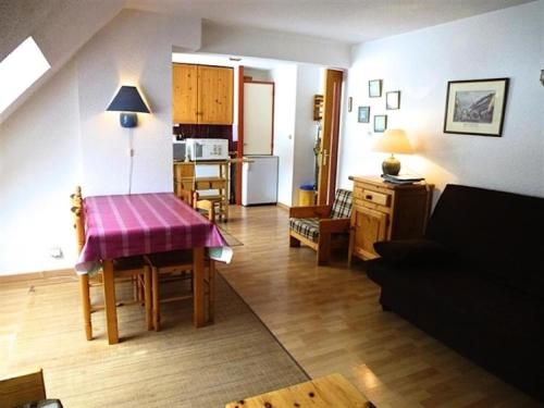 a kitchen and living room with a table and a couch at Résidence Lienz - Studio cabine avec terrasse exposï¿½e Sud MAE-8324 in Barèges