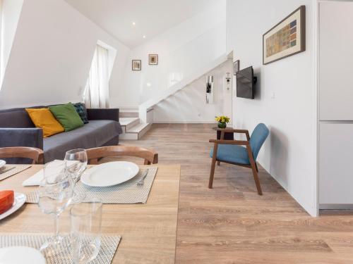 a living room with a couch and a table at LSA Chiado Emenda by Numa in Lisbon