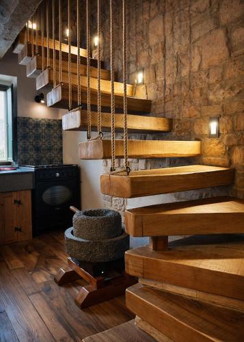 a wooden staircase in a room with a stone wall at Casa Vecchia in Colsantangelo