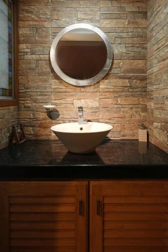 a bathroom with a sink and a mirror at Spicened inn in Cochin