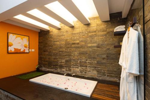 a bathroom with a bath tub in a room at The Siena Village in Chinnakanal