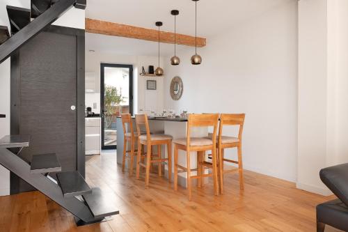 a kitchen and dining room with a table and chairs at Beautiful House avec AC climatisation - terrasse privée - Côté pavé centre-ville Toulouse in Toulouse