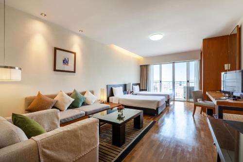 a living room with a couch and a bed at Kantary Hotel Ayutthaya in Phra Nakhon Si Ayutthaya
