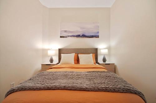 a bedroom with a large bed with two lamps at Bright 3BD Unit Close to Columbia University & Central Park in New York