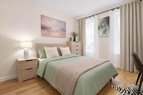 a bedroom with a green bed and a dresser and window at Bright 3BD Unit Close to Columbia University & Central Park in New York